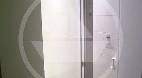 Совмещённый дверной блок (имеющий общий центральный наличник) часто предполагает расположение выключателей не сбоку от двери, а между ними.